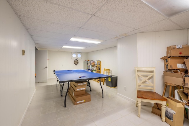 playroom featuring tile patterned flooring, a drop ceiling, and baseboards