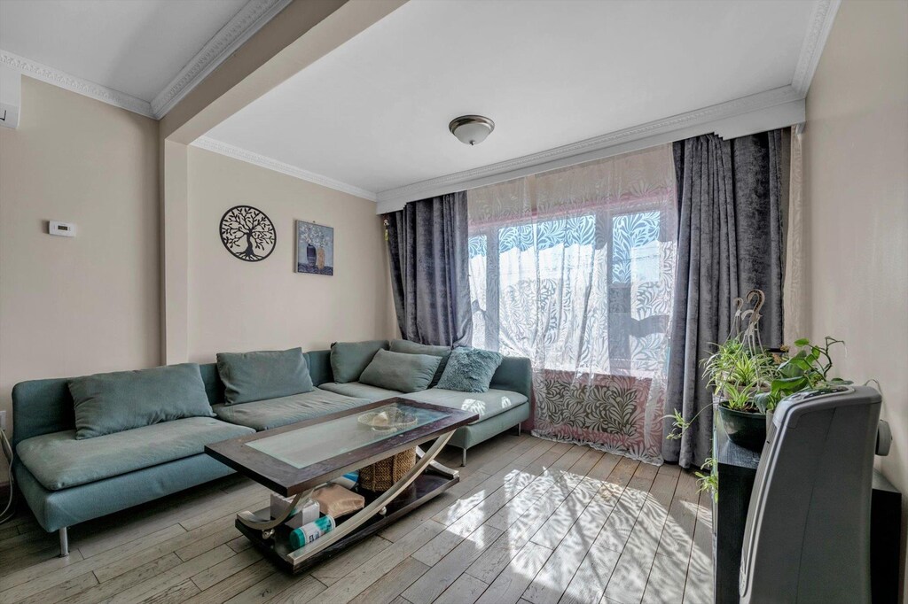 10121 90th St, Ozone Park, NY 11416 - living room with wood finished floors and ornamental molding