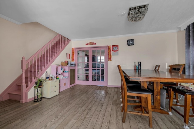 dining space featuring ornamental molding, french doors, wood-type flooring, stairway, and baseboards