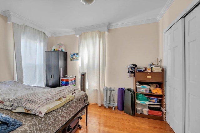 bedroom featuring wood-type flooring and ornamental molding