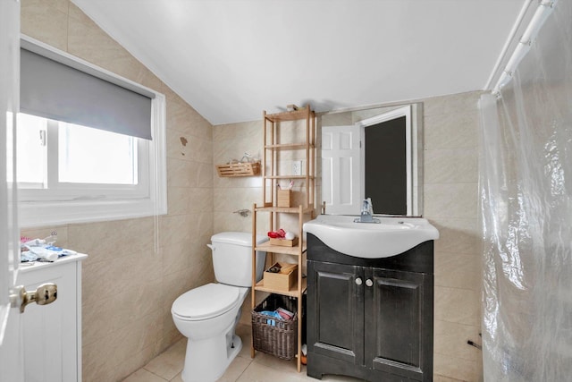 bathroom with toilet, tile walls, tile patterned flooring, lofted ceiling, and vanity