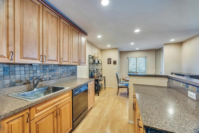 kitchen featuring tasteful backsplash, black dishwasher, recessed lighting, light wood-style flooring, and a sink