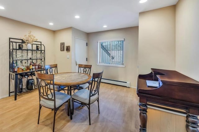 dining area featuring light wood-style flooring, recessed lighting, baseboards, and a baseboard radiator