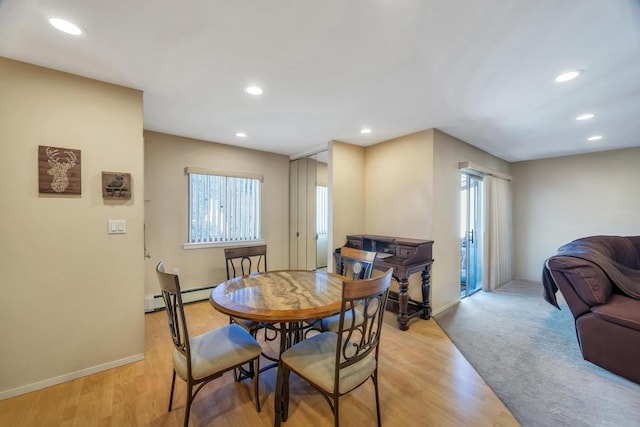 dining area with light wood-style flooring, recessed lighting, a baseboard heating unit, and baseboards