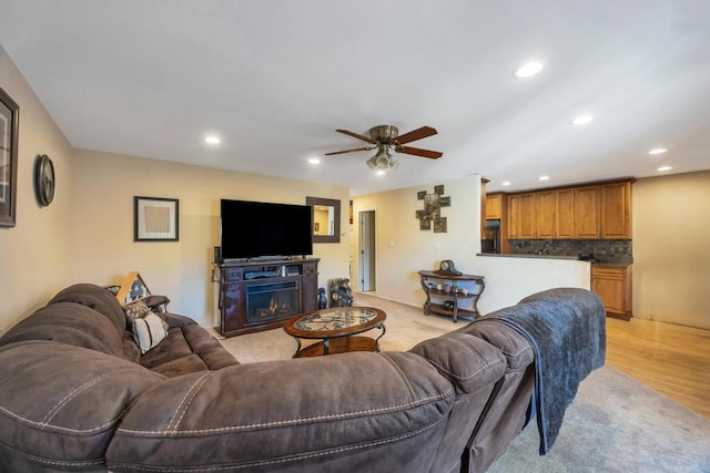 living room with recessed lighting, light wood-style floors, and ceiling fan