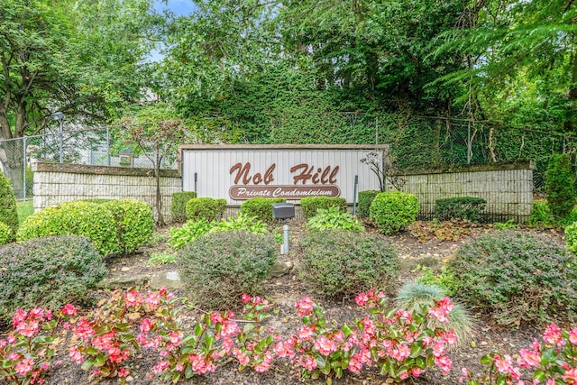 community sign featuring fence