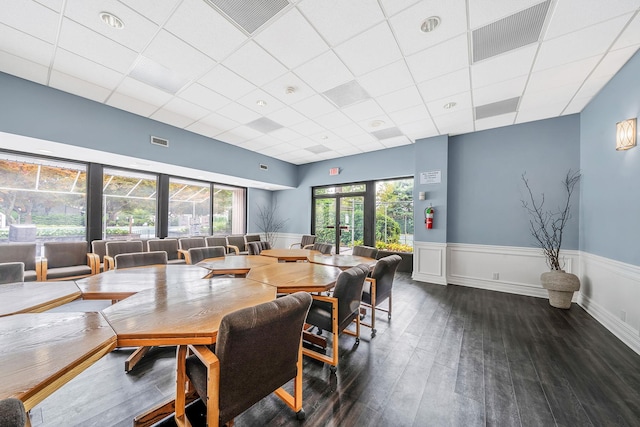 dining room with a wainscoted wall, wood finished floors, and visible vents