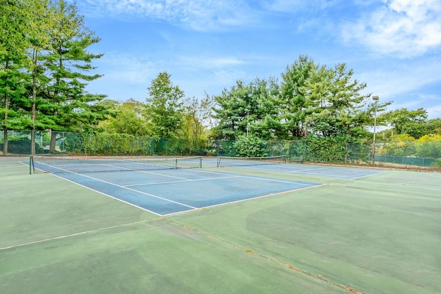 view of tennis court featuring fence