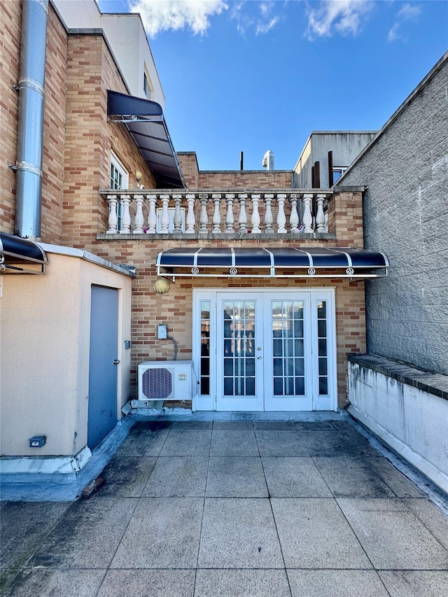 back of house with a patio, ac unit, french doors, and brick siding