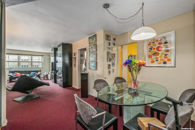 dining area with carpet flooring and baseboards