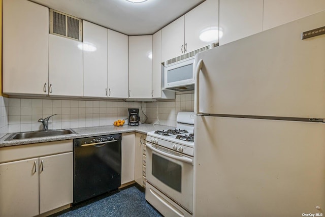 kitchen with tasteful backsplash, visible vents, white appliances, white cabinetry, and a sink