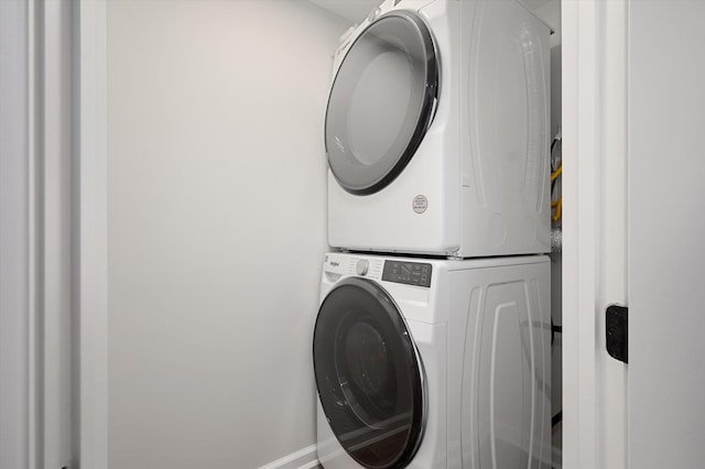 clothes washing area featuring laundry area and stacked washer and dryer