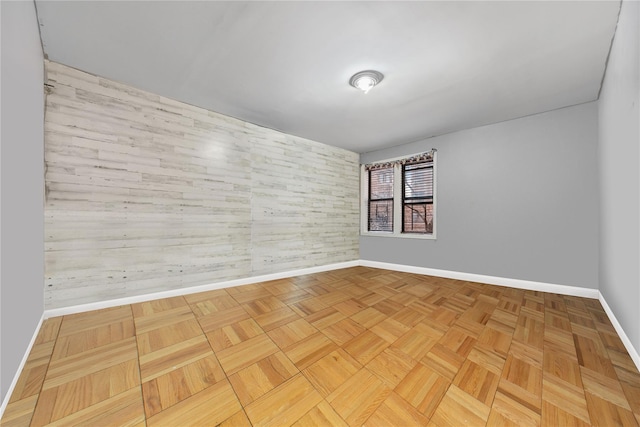 unfurnished room with baseboards