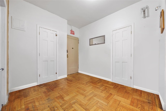 unfurnished room with baseboards