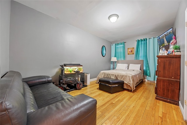 bedroom featuring baseboards and light wood-type flooring