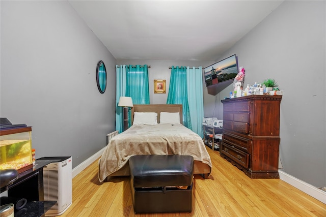 bedroom featuring baseboards and wood-type flooring