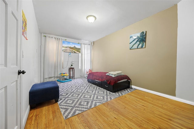 bedroom featuring wood finished floors and baseboards