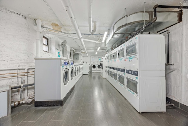 common laundry area with separate washer and dryer and stacked washer and clothes dryer