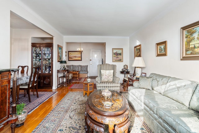 living area featuring light wood finished floors and a chandelier