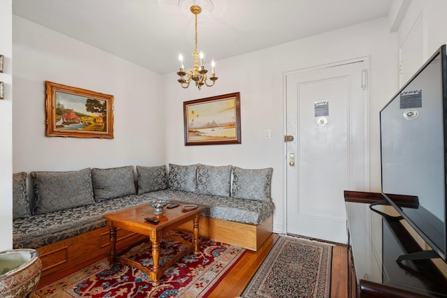 living room with light wood-type flooring and a chandelier