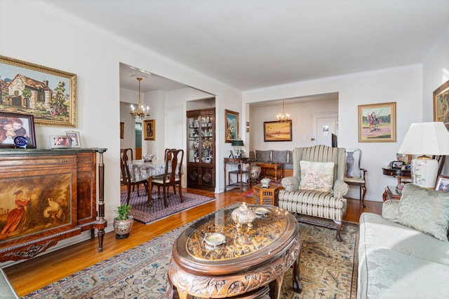 living area featuring a notable chandelier and wood finished floors