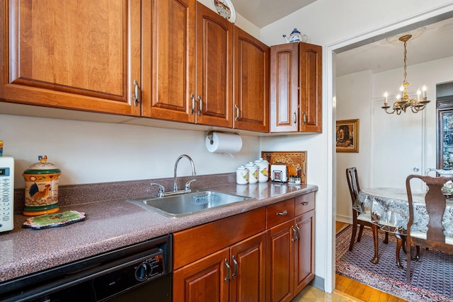 kitchen featuring dishwasher, brown cabinetry, a chandelier, and a sink