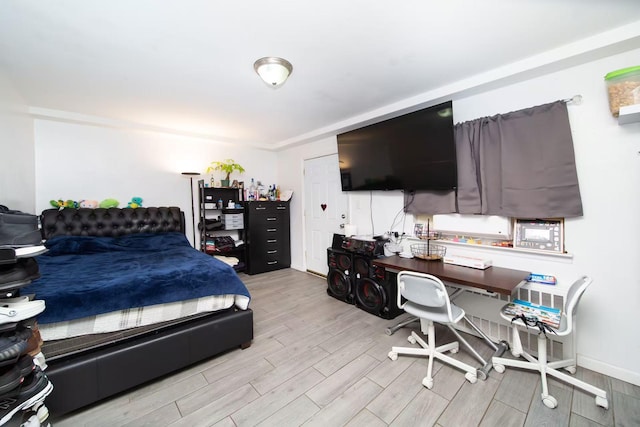 bedroom with baseboards and light wood-style floors