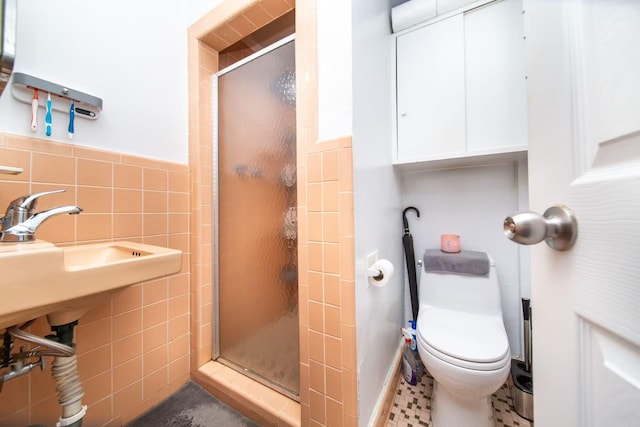 bathroom with a shower stall, tile walls, and toilet
