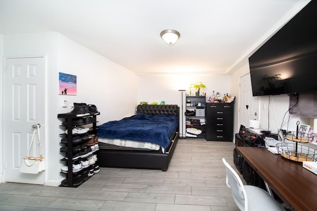 bedroom featuring wood tiled floor
