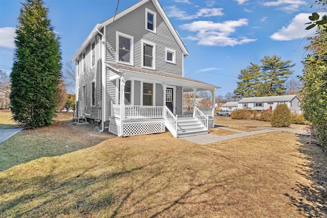 view of front facade with covered porch and a front yard