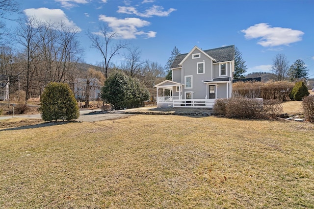 rear view of property with a yard