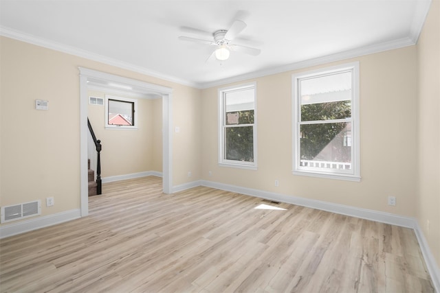 spare room with visible vents, light wood-style flooring, crown molding, and stairs