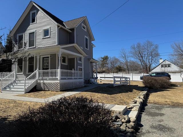 view of front of house with a porch and fence