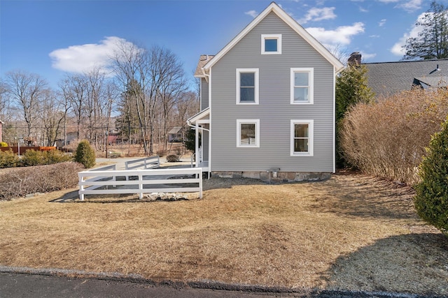 view of side of property with a yard and fence