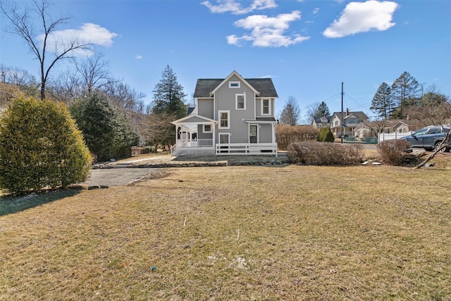 rear view of property with a yard