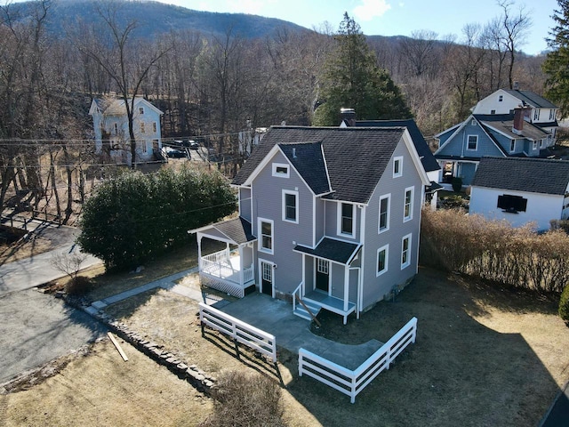 drone / aerial view featuring a forest view