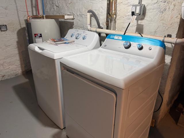 laundry area with water heater, laundry area, and washing machine and clothes dryer