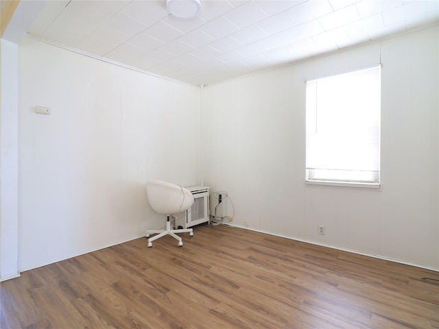 unfurnished room with wood finished floors