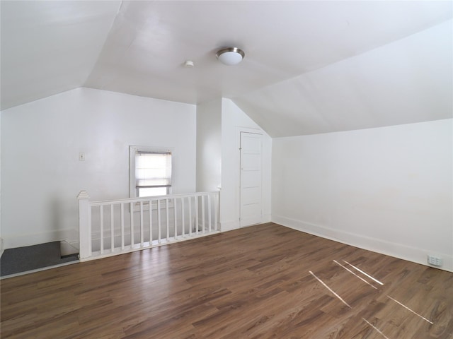 additional living space featuring vaulted ceiling, baseboards, and wood finished floors