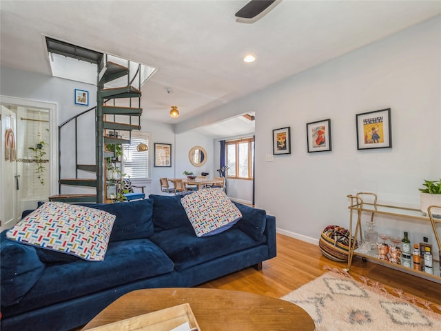 living room featuring recessed lighting, baseboards, and wood finished floors