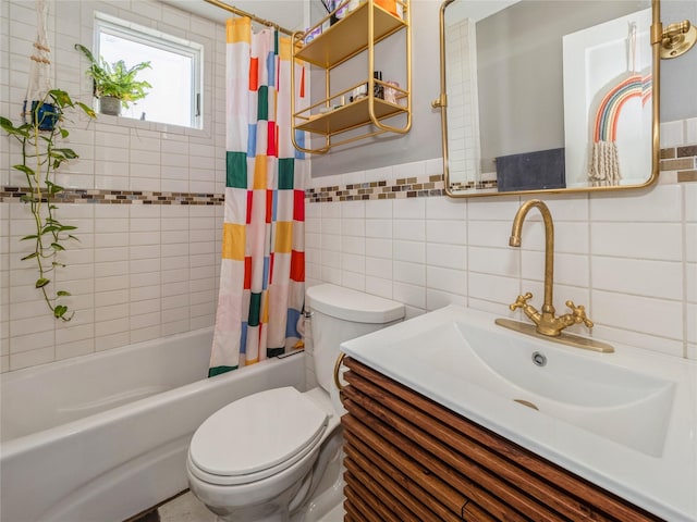 full bath featuring vanity, a wainscoted wall, shower / bath combo with shower curtain, tile walls, and toilet