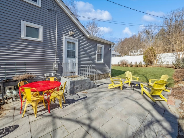 view of patio featuring outdoor dining area and fence