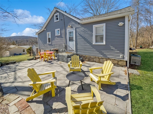 back of property featuring a yard and a patio area