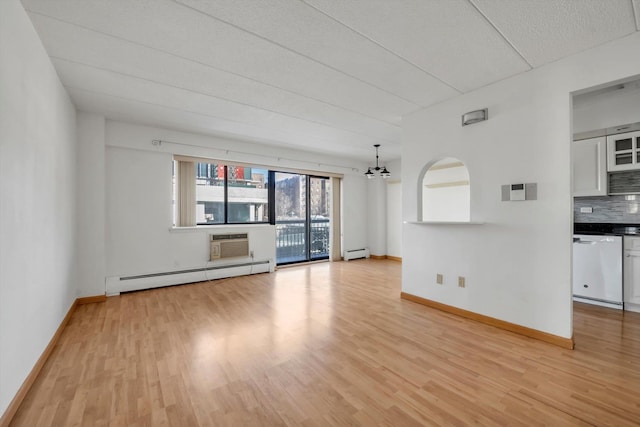 unfurnished living room featuring light wood-style floors, baseboards, baseboard heating, and a wall mounted AC