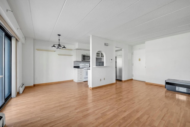 unfurnished living room featuring a baseboard radiator, baseboards, and light wood-style flooring