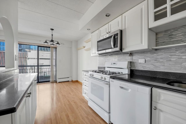 kitchen with a baseboard heating unit, white appliances, light wood-style floors, white cabinets, and decorative backsplash