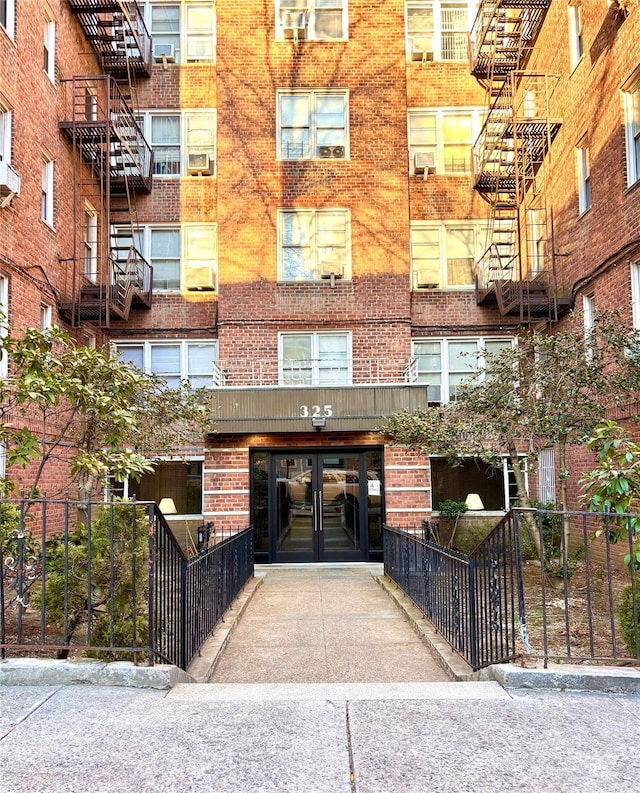 view of property with concrete driveway and fence