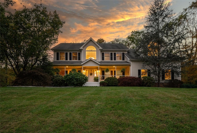 colonial house with a lawn and a porch