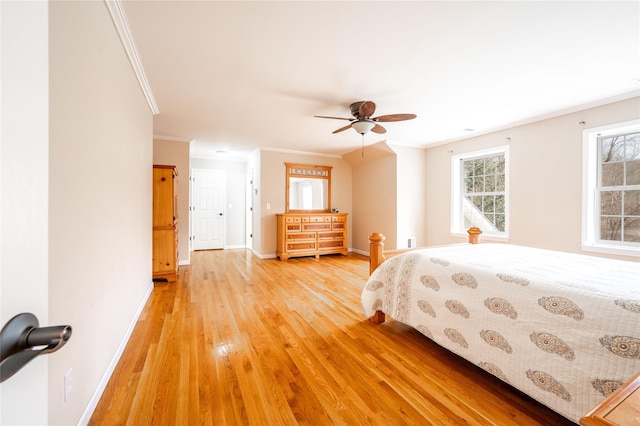 bedroom with light wood finished floors, ceiling fan, crown molding, and baseboards