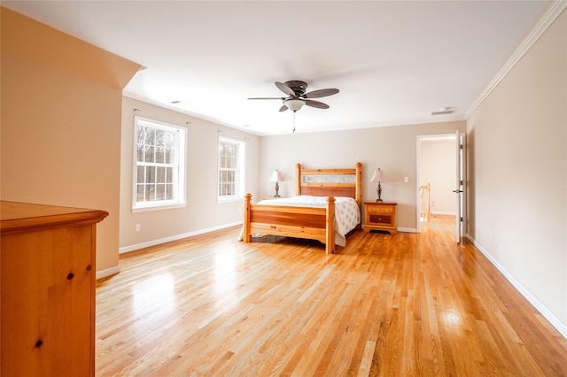 unfurnished bedroom with crown molding, baseboards, and light wood finished floors